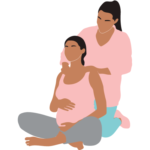 Matrona aplicando masaje a una mujer embarazada.